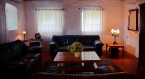 a living room with couches and a coffee table at Kapolcs Cottage in Kapolcs