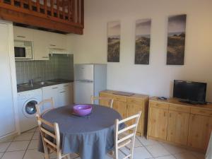 a kitchen with a table with a bowl on it at Maison mitoyenne proche de la plage in Biscarrosse-Plage