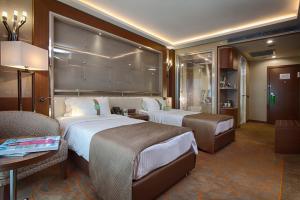 A bed or beds in a room at Holiday Inn Ankara-Kavaklidere by IHG