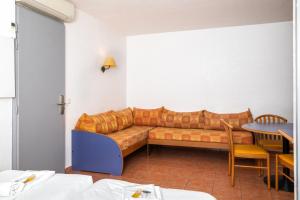 a living room with a couch and a table at SOWELL RESIDENCES Chênes Verts in Saint-Raphaël