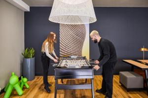 a man and a woman playing a giant chess game at Aparthotel Adagio Birmingham City Centre in Birmingham