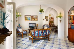 a living room with two chairs and a table at Villa Le Terrazze di Capri in Capri