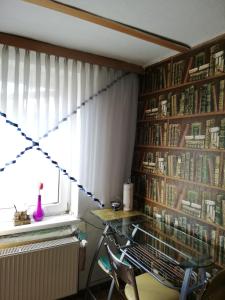 a room with a table and a window with books at Apartment in Salzkammergut in Attnang-Puchheim