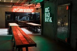a restaurant with tables and a sign that reads big bad bank at Zero Box Lodge Porto in Porto