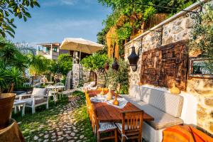 an outdoor patio with a wooden table and chairs at Hotel Unique-Boutique Class - Adults Only in Fethiye
