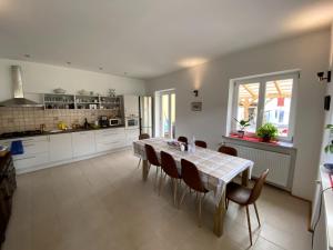 a kitchen and dining room with a table and chairs at The Blue in Csátalja