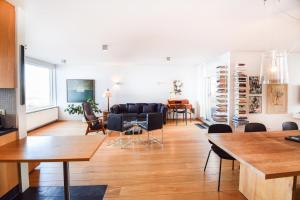 a living room with a couch and a table at Seaside Paradise Apartment in Garðabær