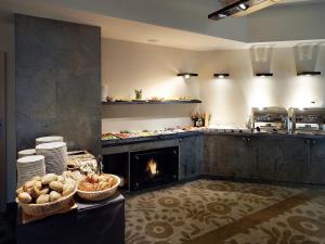 a kitchen with a fireplace in the middle of a kitchen at VacationClub – Dworcowa 1A Apartament 3 in Szklarska Poręba