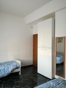 a bedroom with two beds and a mirror at CASA VACANZE LUNA in Seriate