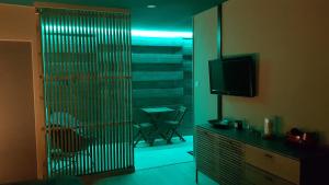 a living room with a sliding glass door with a television at Le lodge origin in Sainte-Suzanne