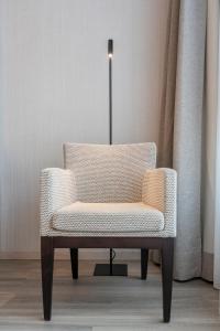 a chair in a room with a lamp at Attica 21 Barcelona Mar in Barcelona