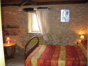 a bedroom with a bed and a window at Gîte de la pouvellerie in Fossemagne +9 photos