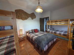 a bedroom with two bunk beds and a lamp at Alojamiento Rural El Paraíso del Chorro in El Chorro +37 photos