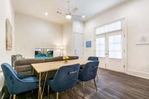 a living room with a table and chairs and a couch at 1 and 2 BR Private Condos Steps Away From French Quarter in New Orleans