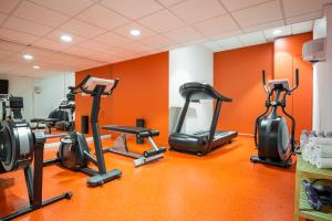 a gym with several exercise bikes in a room at Aparthotel Adagio Paris Bercy Village in Paris