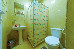 a bathroom with a toilet and a sink and a shower at House 1899 in Kutaisi