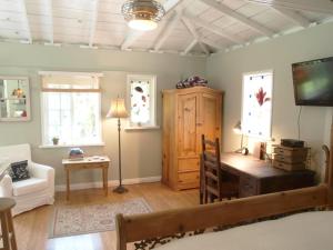 a living room with a desk and a tv at Culver City Escape with Pool, Near Disneyland Park! in Los Angeles