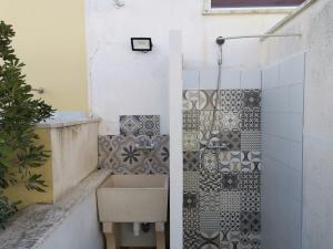 a bathroom with a sink and a shower at Villa Boito in Marina di Pescoluse