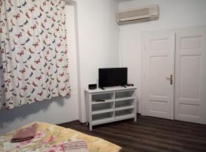 a bedroom with a bed and a television on a dresser at Casablanca City in Varna City