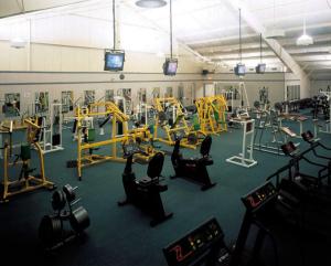 a gym with several treadmills and machines in it at Villa Roma Resort and Conference Center in Callicoon