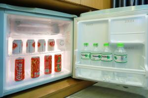a refrigerator filled with lots of different types of drinks at Lucky Star Hotel 266 De Tham in Ho Chi Minh City