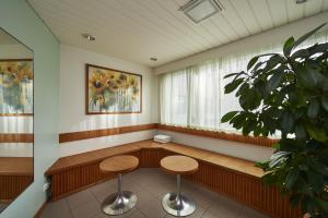 a waiting room with two tables and a window at Holiday Inn Helsinki-Vantaa Airport, an IHG Hotel in Vantaa