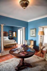 a living room with blue walls and a coffee table at Casa do Ribeiro in Guimarães