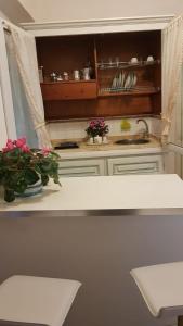 a kitchen with a sink and flowers on a counter at Casa Lulù in Minori +21 photos