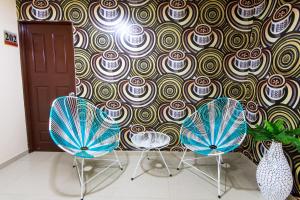 two chairs and a table in a room at Hotel Marina Suites By GH Suites in Cartagena de Indias