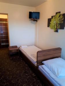 Posteľ alebo postele v izbe v ubytovaní Motel Orion Wolsztyn