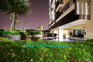 a building with a swimming pool in front of it at H2H - Botanical Majestic Ipoh in Ipoh