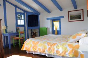 a blue and white bedroom with a bed and a desk at Domaine Xixtaberri in Cambo-les-Bains