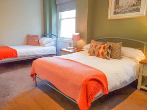 A bed or beds in a room at The Rising Sun Inn 