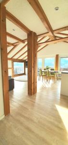 a large room with tables and chairs and windows at Sanosueno in Sonthofen