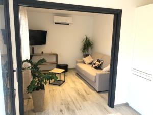 a living room with a couch and a tv at Chez Fred et Marie in Figari