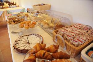 a table with many different types of bread and pastries at Hotel Alma in Campo nell'Elba