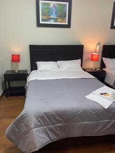 - une chambre avec un grand lit blanc et deux lampes dans l'établissement ORBEGOSO - Trujillo, à Trujillo