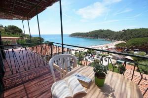 a balcony with a table and a view of a beach at Hotel Alma in Campo nell'Elba