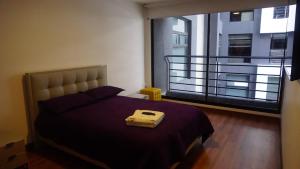 1 dormitorio con 1 cama y balcón en 1440 Lujuso Departamento en Quito - La Recoleta, en Quito