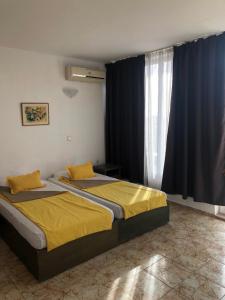 A bed or beds in a room at Sunny Varshava Hotel