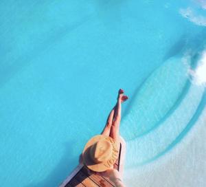 a person in a pool with their hands in the water at Masseria Trulli&Stelle B&B in Noci