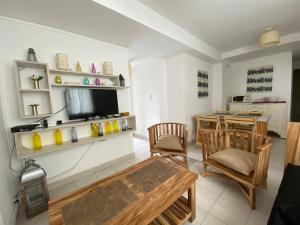 a living room with a table and chairs and a television at APART BALCARCE in San Miguel de Tucumán