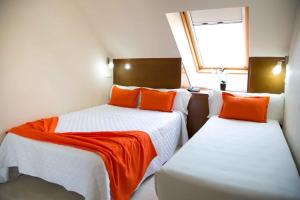 A bed or beds in a room at Hostal San Marcos