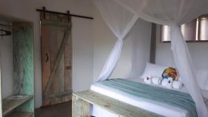 Postel nebo postele na pokoji v ubytování Pousada Vila Cacau