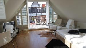 a bedroom with a bed and a table and a balcony at Prince On The Roof in Amsterdam