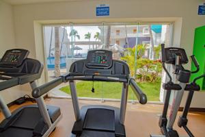 a gym with two treadmills in front of a window at Star Palace Beach Hotel in Mazatlán
