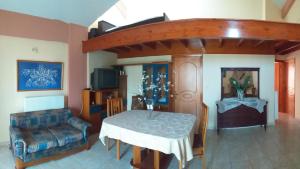 a living room with a table and a bed at sea view in Amaliás