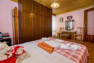 a bedroom with two stuffed animals sitting on a bed at Lazaros Maria in Maries
