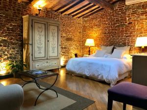 a bedroom with a large bed and a brick wall at Capri Moon Guest House in Florence