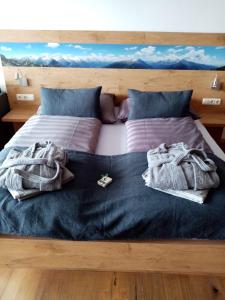 a bed with blankets and towels on top of it at Apartment Sandra in Bad Goisern